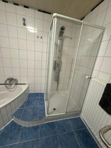 a bathroom with a shower and a tub and a sink at Haus Teveren in Geilenkirchen +10 photos