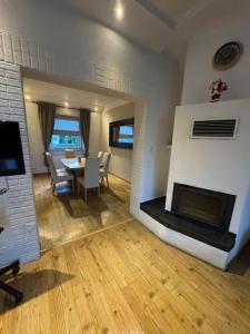 a living room with a table and a fireplace at Haus Teveren in Geilenkirchen