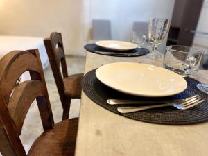 een tafel met borden en bestek bovenop bij 1-Bed Loft in Oaxaca - Steps from Downtown in Oaxaca City