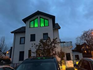 una casa bianca con finestre verdi in cima di Ferienwohnung Steinberg a Dietzenbach