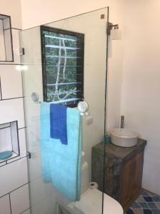 a bathroom with a toilet and a sink and a mirror at Casitas Escondidas in Playa Pelada +40 photos