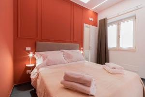 a bedroom with a bed with two towels on it at Dimora Fortunato in Bernalda