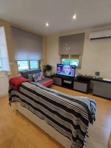 a living room with a large bed and a flat screen tv at sol y arena in Santa Pola