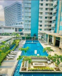 an image of a swimming pool at a hotel at Simple White Scape at Mesavirre Bacolod in Bacolod