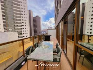 a balcony with a table and chairs on a building at Co-House Tambaú in João Pessoa