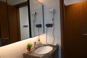 a bathroom with a sink and a mirror at K2 Hostel Shenzhen North Railway Stn Store in Shenzhen +21 photos