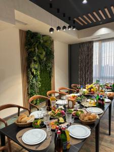 a long table with food on it with chairs at Fidji Hotel in Yerevan