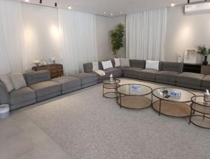 a large living room with couches and tables in it at Al Ain Farm Escape with Private Pool , Mini Golf , and Firepit in Bin Aḩmad +6 photos