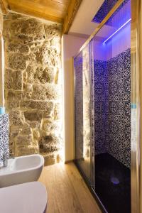 a bathroom with a glass shower and a sink at Grand Suite Gioberti Elegante nel cuore di Alghero in Alghero +11 photos