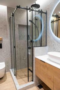 a shower with a glass door in a bathroom at VASIADIS apartment in Síndos +24 photos