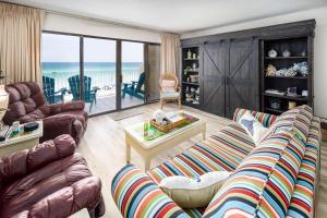 a living room with couches and a view of the ocean at Gulf Side 402 Pet friendly gulf front condo in Fort Walton Beach