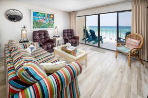 a living room with a couch and chairs and a balcony at Gulf Side 402 Pet friendly gulf front condo in Fort Walton Beach