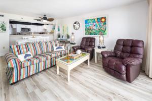 a living room with two couches and a coffee table at Gulf Side 402 Pet friendly gulf front condo in Fort Walton Beach