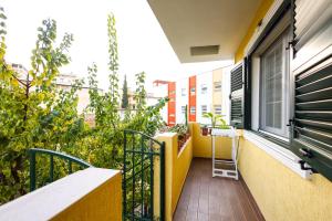 a balcony of a building with a window and plants at Apartment with garden in the center of Durres in Durrës +34 photos