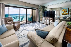 a living room with a couch and a television at Gulf Side 601 Pet friendly gulf front condo in Fort Walton Beach