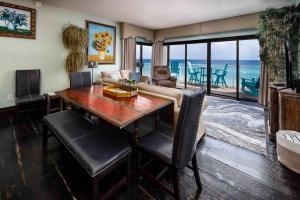 a living room with a table and a view of the ocean at Gulf Side 601 Pet friendly gulf front condo in Fort Walton Beach