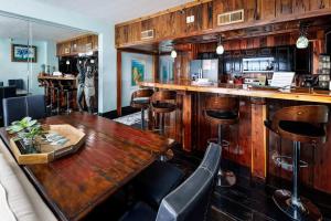 a bar with a wooden table and bar stools at Gulf Side 601 Pet friendly gulf front condo in Fort Walton Beach +26 photos