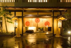 a building with umbrellas on it at night at Kanazawa Chaya in Kanazawa