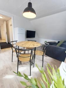 a living room with a table and chairs and a couch at Charming 1-bedroom Apartment A in Hjørring