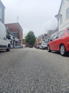 a group of cars parked on a city street at Charming 1-bedroom Apartment A in Hjørring