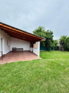 a building with a bench on a grass field at Casa en Nono traslasierra in Nono