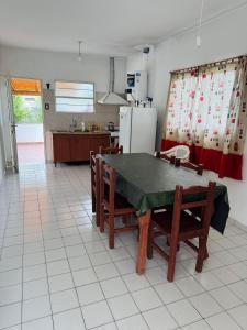 a kitchen with a table and chairs and a refrigerator at Casa en Nono traslasierra in Nono