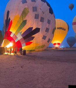 a group of hot air balloons in the desert at Luxor Nile palace in Luxor