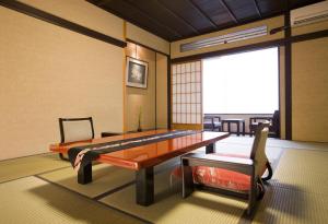 a living room with a table and a chair at Kanazawa Chaya in Kanazawa