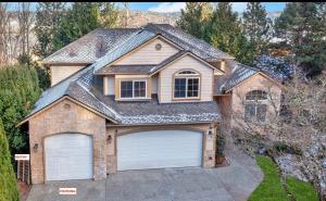 a house with two garage doors in a driveway at Spacious Basement with independent entry and yard in Issaquah