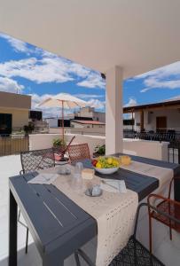 a table with a bowl of fruit on a balcony at Dimora Fortunato in Bernalda