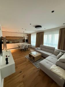 a living room with a couch and a table at Prestige Lux Andan - Apart hotel Horizont Jahorina in Jahorina +33 photos