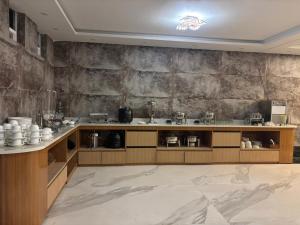 a kitchen with a counter with a sink and a counter at Muskan Mount View Retreat, Mukteshwar in Mukteswar +58 photos