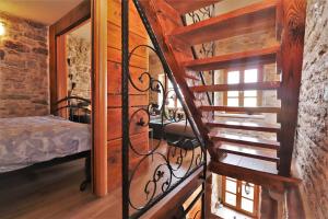 a spiral staircase in a room with a bedroom at Downtown stone house in Vodice