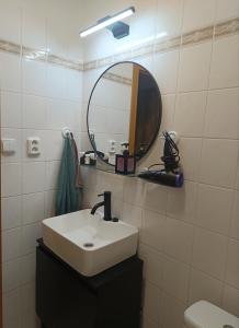 a bathroom with a sink and a mirror at Apartmán 19 MEZONET in Jáchymov +15 photos