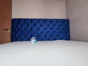a can of soda sitting on top of a bed at Avian suits in Kisumu