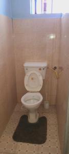 a bathroom with a toilet in a small room at Avian suits in Kisumu