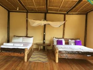 Postel nebo postele na pokoji v ubytování Migogo gorilla lodge