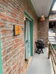 a brick wall with a door on a patio at MOVE quartos de hotel in Pipa