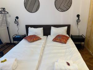 a bed with two pillows on it in a bedroom at Wolność in Elblag