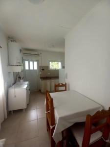 een witte kamer met een bed en een keuken bij Viento Sur 2 in Estancia El Polomo