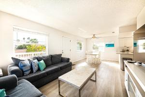 a living room with a couch and a table at 2bd 2ba Beachside E 3Min to Beach Pool! in Clearwater Beach