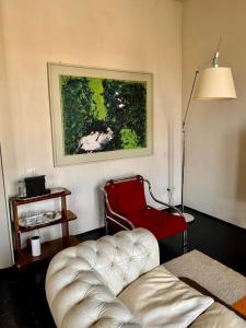 a living room with a couch and a red chair at Terrazza sul Duomo in Arezzo +33 photos