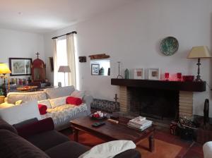 a living room with a couch and a fireplace at Casa das Glicínias in Óbidos