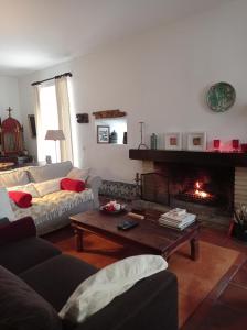 a living room with a couch and a fireplace at Casa das Glicínias in Óbidos +45 photos