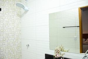 a bathroom with a mirror and a sink at Hotel Ipe in Barreirinhas +29 photos