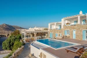 a villa with a swimming pool and a house at Manolia View Mykonos in Tourlos