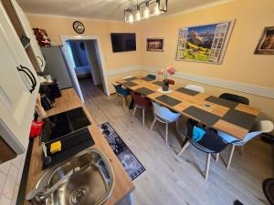 a room with a table and chairs and a kitchen at Haus Bellaflora Apartman in Haus im Ennstal +23 photos