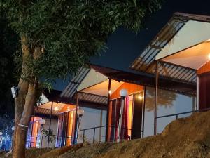 a house lit up at night at Pawan leke cottage in Kolvan