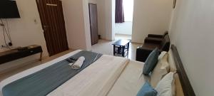 a bedroom with a bed in a room at HOTEL MAHER Inn in Ahmedabad