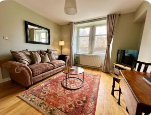 a living room with a couch and a table at Bed on the Brae in Inverness